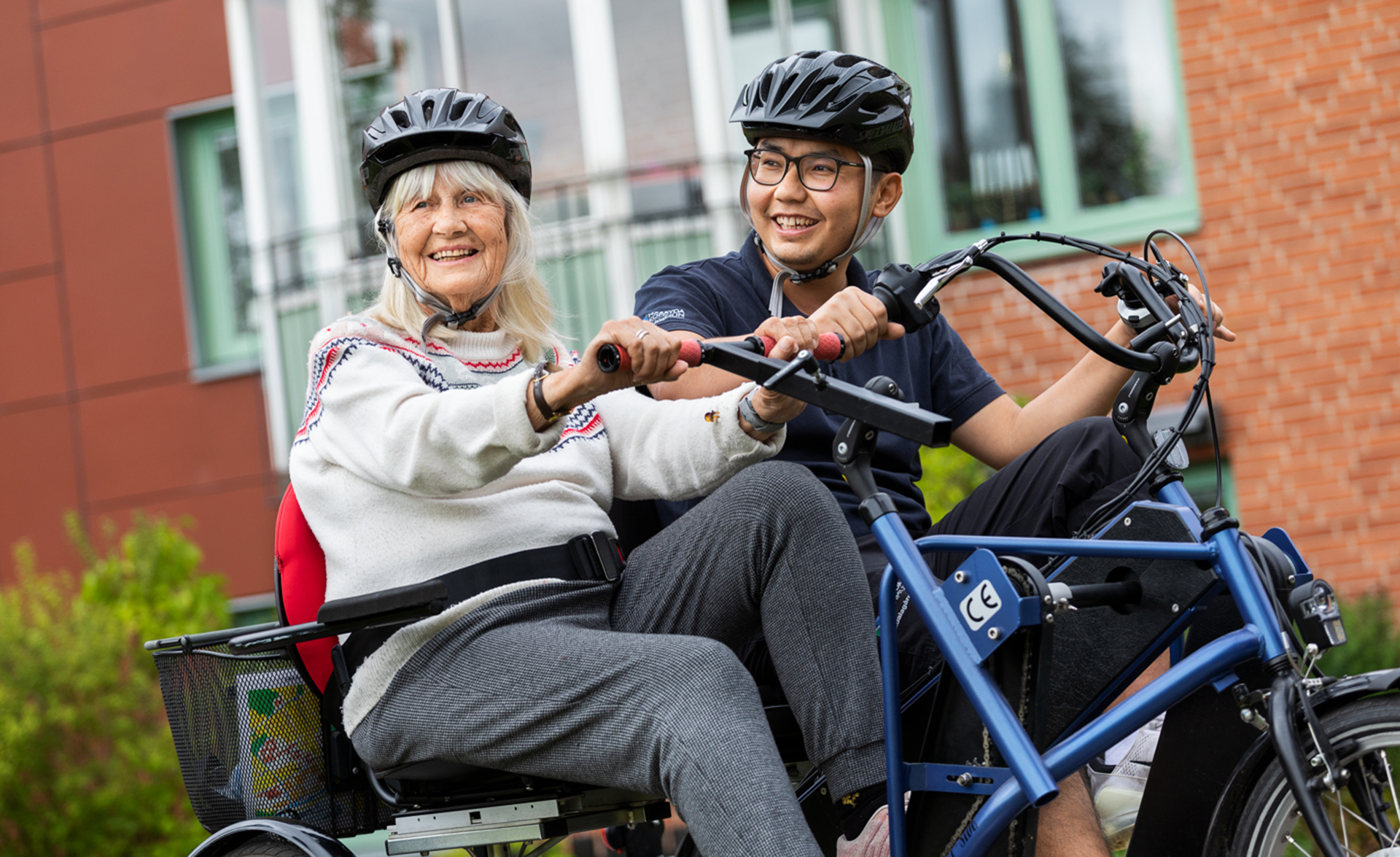 Personal inom äldreomsorgen cyklar tillsammans med brukare